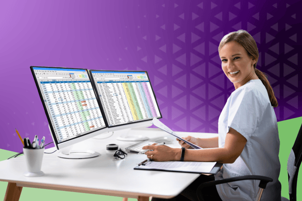 Medical billing specialist reviewing denial data on dual monitors, analyzing reports and documentation to prevent claim denials in a healthcare setting.
