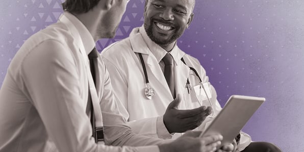 Medical doctors looking at a tablet