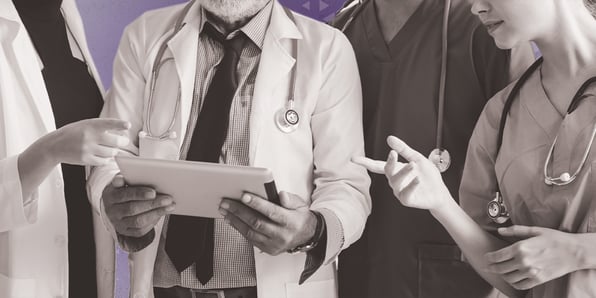 Group of doctors looking at a tablet