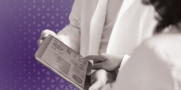 Doctors looking at analytics on a tablet